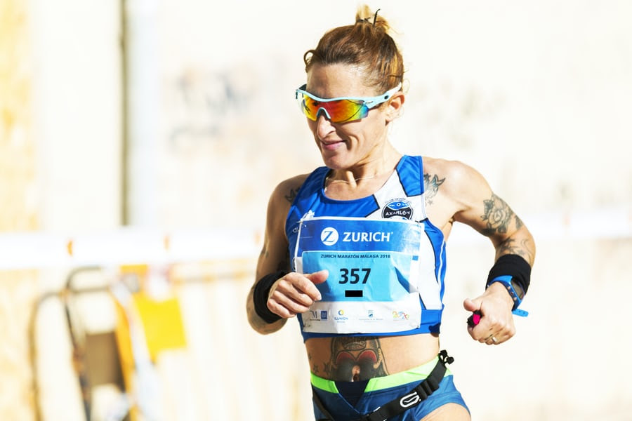 Woman with sunglasses running ultramarathon